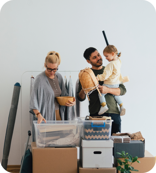 Young family with child moving boxes, illustrating Homage AI's property trade-in process.