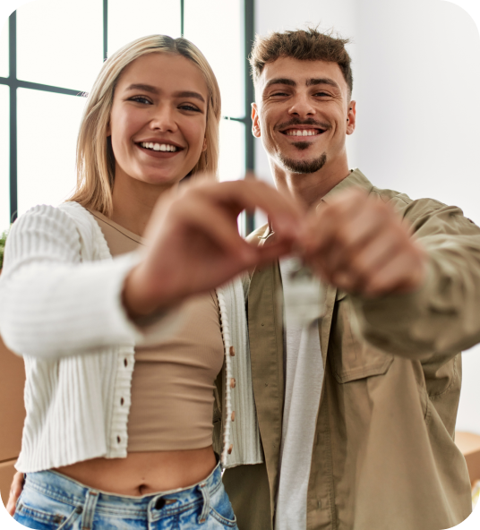 Smiling couple holding key to their new home traded in via Homage AI